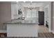 Updated kitchen with stainless steel appliances, granite countertops, and tiled floors at 609 E Southern Ave, Indianapolis, IN 46203