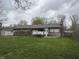 A large backyard features manicured lawns and a private shed for extra storage at 613 Rahkewood Dr, Indianapolis, IN 46217