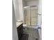 Clean bathroom featuring a single sink vanity, toilet, and shower with sliding glass doors at 613 Rahkewood Dr, Indianapolis, IN 46217