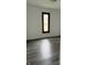 Bedroom with laminate flooring, white walls, and a window at 613 Rahkewood Dr, Indianapolis, IN 46217