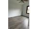 Well-lit bedroom featuring laminate flooring, white walls, and a window at 613 Rahkewood Dr, Indianapolis, IN 46217
