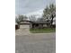 Charming single-story home featuring stone accents, a two-car garage, and a well-maintained front yard at 613 Rahkewood Dr, Indianapolis, IN 46217