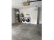 Garage with modern washer and dryer units plus a water heater at 613 Rahkewood Dr, Indianapolis, IN 46217