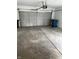 Spacious garage with concrete flooring and an automatic door at 613 Rahkewood Dr, Indianapolis, IN 46217