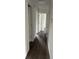 Hallway featuring wood-look floors, neutral walls, and white doors leading to various rooms in the home at 613 Rahkewood Dr, Indianapolis, IN 46217