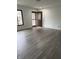Bright living room showcasing newly installed laminate flooring, fresh paint, and a welcoming front door at 613 Rahkewood Dr, Indianapolis, IN 46217