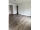 A spacious and bright living room with stylish laminate flooring and fresh white walls at 613 Rahkewood Dr, Indianapolis, IN 46217