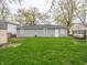 Spacious backyard with lush grass, detached storage, and mature trees for outdoor enjoyment at 6189 Vigo Dr, Clayton, IN 46118