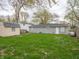 Large grassy backyard with a storage shed and detached garage, perfect for outdoor activities at 6189 Vigo Dr, Clayton, IN 46118