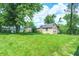 Backyard featuring a large green yard with a storage shed and surrounding trees at 6189 Vigo Dr, Clayton, IN 46118