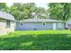 The backyard features a grass lawn, a small shed and a house with light siding at 6189 Vigo Dr, Clayton, IN 46118