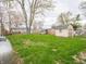 Expansive backyard featuring lush green grass, mature trees, and a storage shed at 6189 Vigo Dr, Clayton, IN 46118