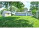 View of a spacious backyard with green grass, partial fencing, and a shed at 6189 Vigo Dr, Clayton, IN 46118