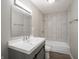 This bathroom features white tile surround, a dark vanity, and modern lighting at 6189 Vigo Dr, Clayton, IN 46118