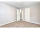 This bedroom features neutral walls, carpet flooring, a ceiling light, and two entry doors at 6189 Vigo Dr, Clayton, IN 46118
