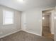 Well-lit bedroom with plush carpeting and a convenient access door, ideal for relaxation at 6189 Vigo Dr, Clayton, IN 46118