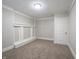 This bedroom features neutral carpet, white trim, and a flush mount ceiling light at 6189 Vigo Dr, Clayton, IN 46118