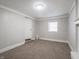 This bedroom features neutral carpet, a window, and a flush mount ceiling light at 6189 Vigo Dr, Clayton, IN 46118
