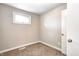 Cozy bedroom featuring neutral walls, carpet, a window, and a white door at 6189 Vigo Dr, Clayton, IN 46118