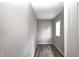 A small bedroom offering wood-look flooring, a window, neutral paint, and wood paneling at 6189 Vigo Dr, Clayton, IN 46118
