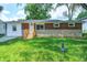 Charming single-story home featuring a well-maintained lawn and brick facade with a new wooden stair at 6189 Vigo Dr, Clayton, IN 46118