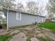 Home exterior with light gray siding and a white door, small yard with a vintage AC unit at 6189 Vigo Dr, Clayton, IN 46118