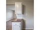 This kitchen features white cabinetry, white subway tile backsplash, and wood countertops at 6189 Vigo Dr, Clayton, IN 46118