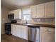 Well-lit kitchen featuring bright white cabinets, a stainless steel dishwasher, and wood countertops at 6189 Vigo Dr, Clayton, IN 46118