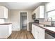 Bright and airy kitchen boasts white cabinets, stainless steel appliances, and natural wood countertops at 6189 Vigo Dr, Clayton, IN 46118