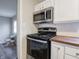 Close-up of the kitchen area, showing appliances, countertop, and freshly painted walls at 6189 Vigo Dr, Clayton, IN 46118