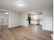 Open-concept living space featuring new laminate floors with views into the adjacent kitchen at 6189 Vigo Dr, Clayton, IN 46118