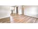 Bright living room with wood-look flooring and an open doorway to the kitchen with stainless steel appliances at 6189 Vigo Dr, Clayton, IN 46118