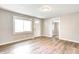 A bright living room featuring wood-look flooring, neutral paint, and natural light through a large window at 6189 Vigo Dr, Clayton, IN 46118