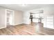 Open concept layout that connects the living area to the kitchen with white cabinetry and stainless appliances at 6189 Vigo Dr, Clayton, IN 46118