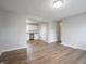 Spacious living room with new laminate floors with a doorway leading into the kitchen at 6189 Vigo Dr, Clayton, IN 46118