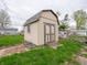 Backyard features a small storage shed with a pair of wooden doors and a small window at 6189 Vigo Dr, Clayton, IN 46118