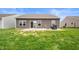 Backyard featuring a concrete patio, fire pit, outdoor seating and green grass at 6323 Emerald Field Way, Indianapolis, IN 46221