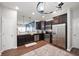 Modern kitchen with stainless steel appliances, dark wood cabinets, and a breakfast bar at 6323 Emerald Field Way, Indianapolis, IN 46221
