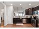 Well-lit kitchen with stainless steel appliances and granite countertops, open to living area at 6323 Emerald Field Way, Indianapolis, IN 46221