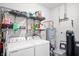 Laundry room with washer, dryer, water heater, water softener and storage shelves at 6323 Emerald Field Way, Indianapolis, IN 46221
