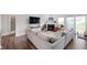 Open-concept living room featuring a cozy fireplace, ample seating and great lighting at 6323 Emerald Field Way, Indianapolis, IN 46221