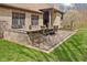 Brick patio and outdoor kitchen with chairs and grill overlooking the landscaped lawn at 6841 W Glory Maple Dr, McCordsville, IN 46055