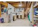 Functional basement workshop area with pegboard, storage cabinets, and concrete floor at 6841 W Glory Maple Dr, McCordsville, IN 46055