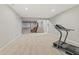 Spacious finished basement with exercise equipment and a home theater setup at 6841 W Glory Maple Dr, McCordsville, IN 46055