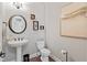 Stylish powder room with pedestal sink, decorative art, and elegant fixtures at 6841 W Glory Maple Dr, McCordsville, IN 46055