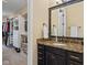 Bathroom vanity featuring granite countertops, modern fixtures, and direct access to the closet at 6841 W Glory Maple Dr, McCordsville, IN 46055