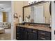 Bathroom vanity featuring granite countertops, ample storage, dark cabinetry and modern fixtures at 6841 W Glory Maple Dr, McCordsville, IN 46055