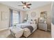 Relaxing bedroom with a decorative ceiling fan, plush bedding, and mirrored accents at 6841 W Glory Maple Dr, McCordsville, IN 46055