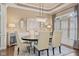 Formal dining room features stylish chandelier, neutral paint, and an oval dining table for six at 6841 W Glory Maple Dr, McCordsville, IN 46055