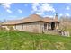 Brick home with backyard featuring a patio with outdoor kitchen and manicured lawn at 6841 W Glory Maple Dr, McCordsville, IN 46055